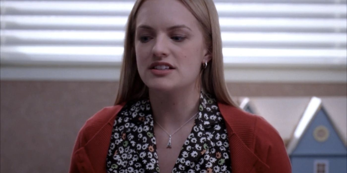 Elisabeth Moss as Nina standing in front of a dollhouse in Grey's Anatomy