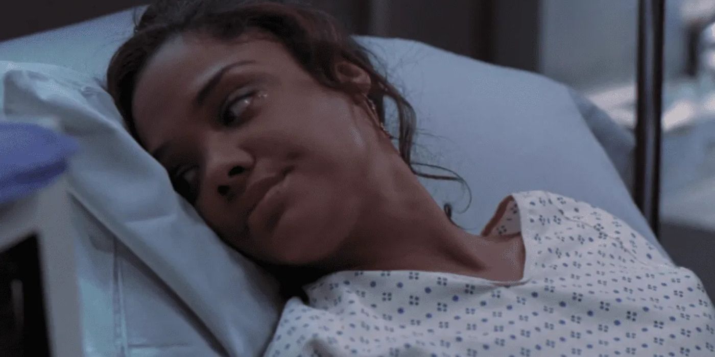 Tessa Thompson lying in scrubs in a hospital bed in Grey's Anatomy