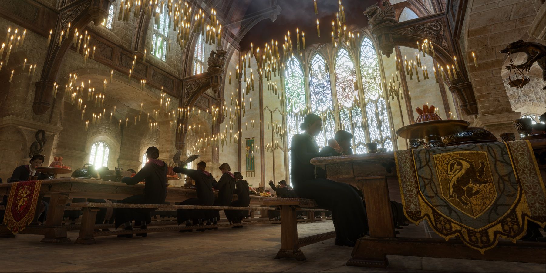 Image of the hogwarts legacy dining hall with students eating at the tables and candles floating above