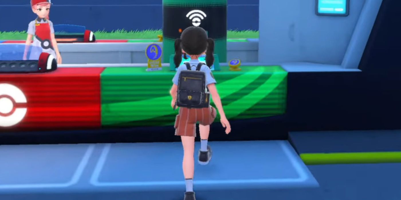 A Character walking towards a TM machine in Pokémon Scarlet & Violet