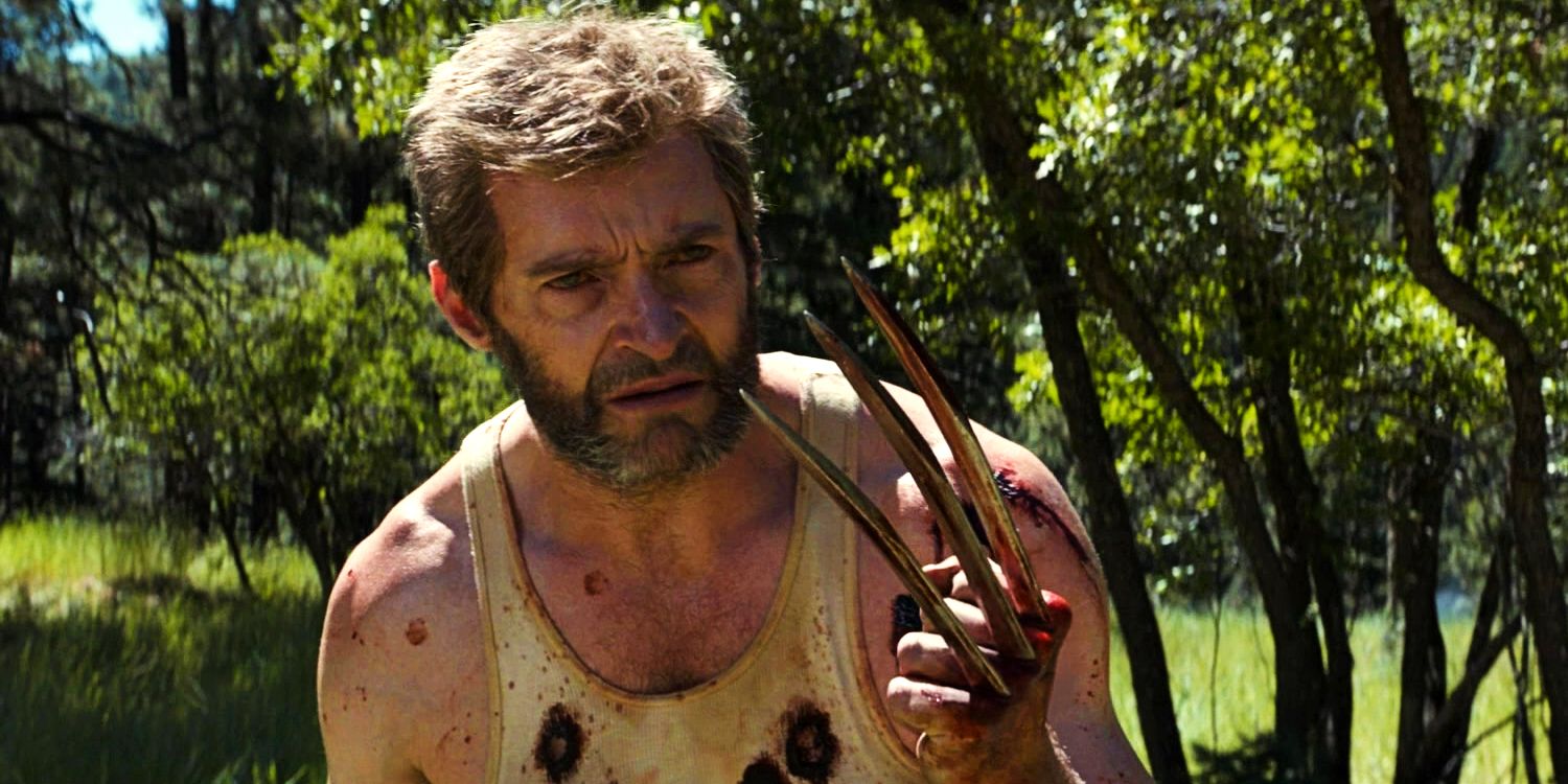 Hugh Jackman as Wolverine holding up claw at the end of Logan