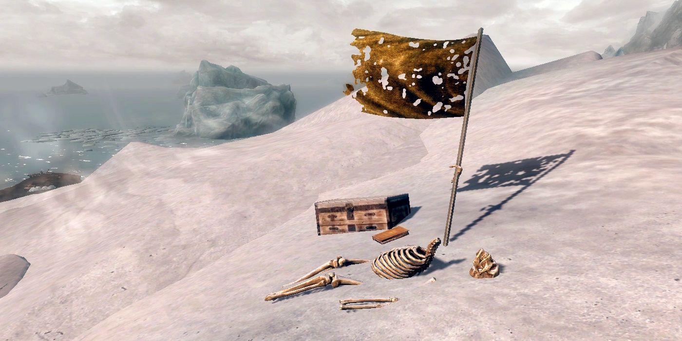 Restos esqueléticos medio enterrados en la nieve en Skyrim con una bandera y un cofre al lado.