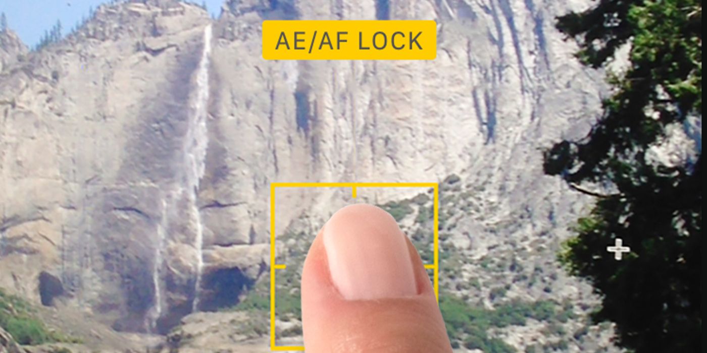 A thumb presses the AE/AF lock function on iPhone