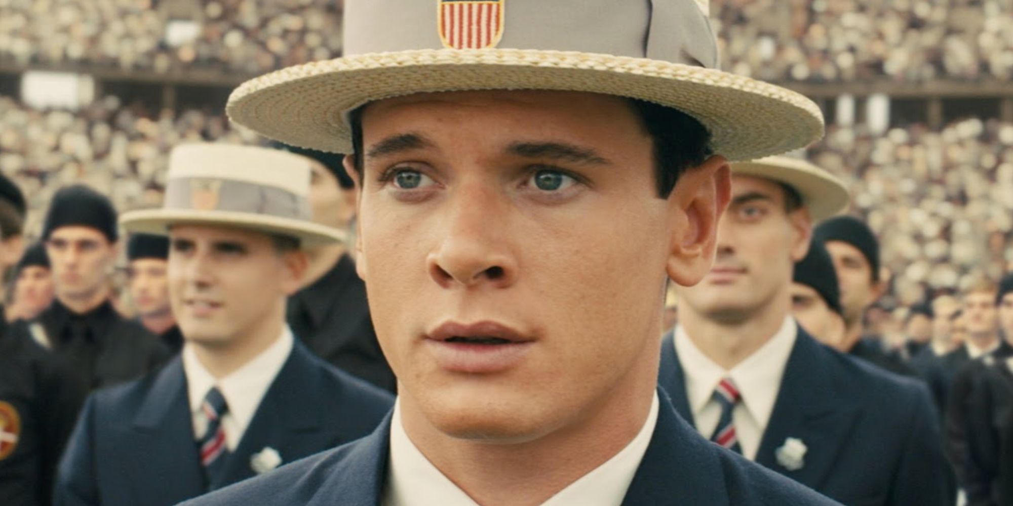 Jack O'Connell wearing a hat and looking engrossed in Unbroken