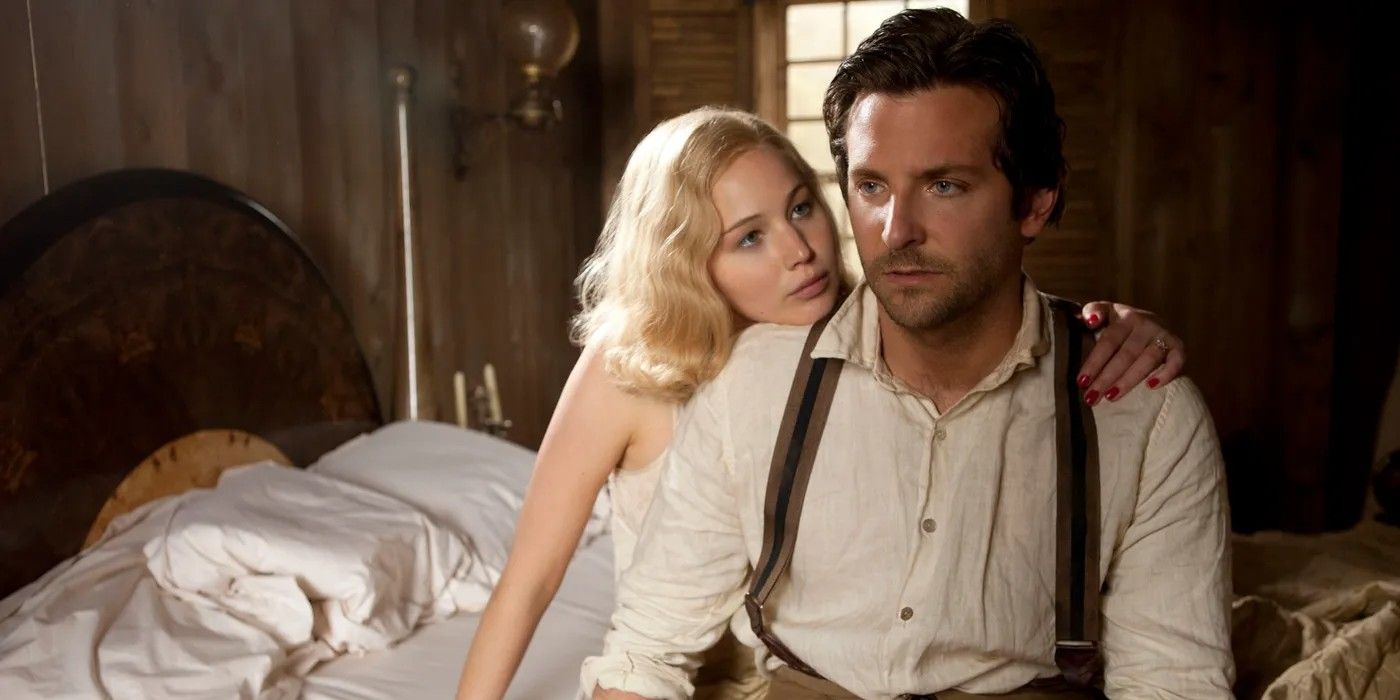 Jennifer Lawrence and Bradley Cooper on a bed in Serena