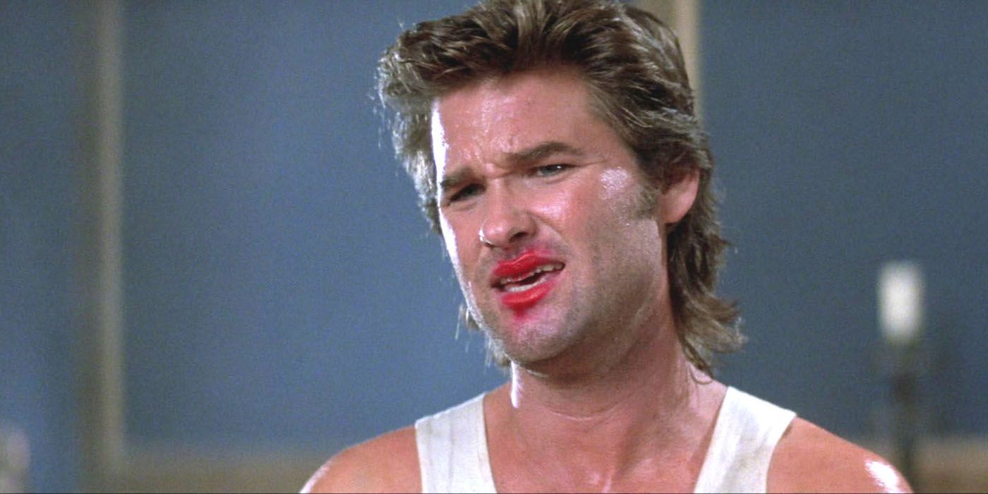 Kurt Russell looking angry with lipstick hilarious smeared on his face in Big Trouble in Little China