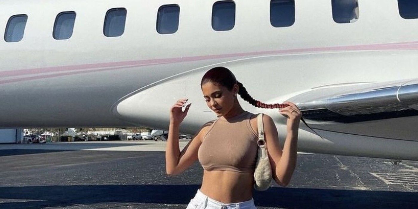 Kylie Jenner next to a plane
