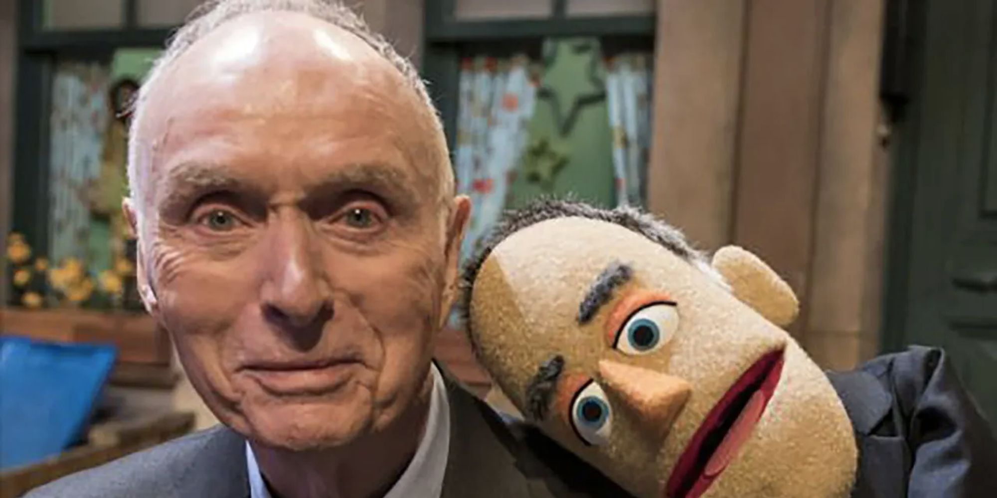 Lloyd N. Morrisett with a puppet from Sesame Street