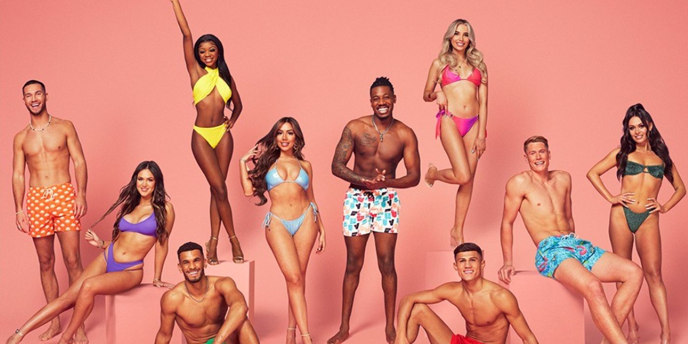 Love Island UK season 9 cast posing in swimsuits peach background