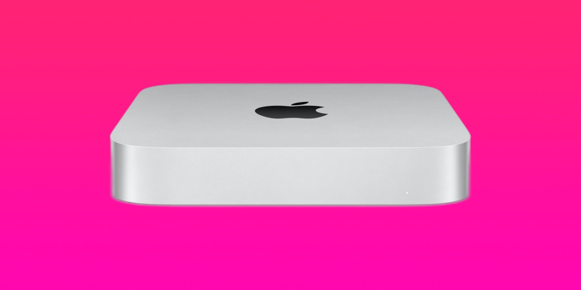 An M2-powered Mac mini against a pink gradient background.