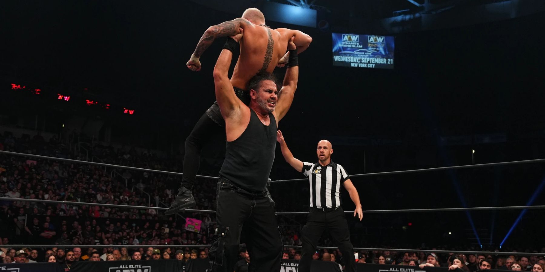 Matt Hardy lifts Darby Allin above his head for a slam during their match on AEW Rampage in 2022.
