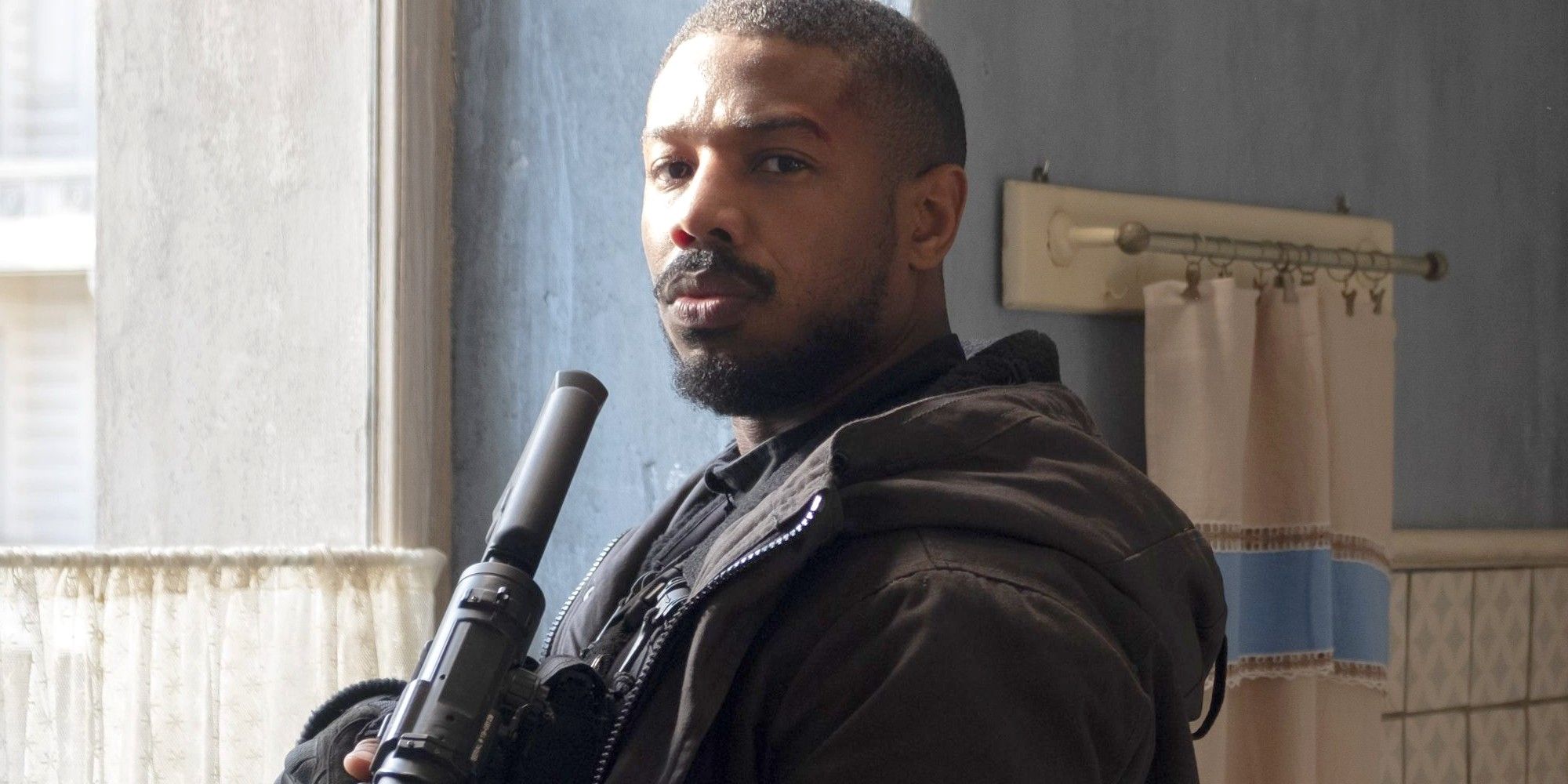 Michael B Jordan holds a gun in Without Remorse