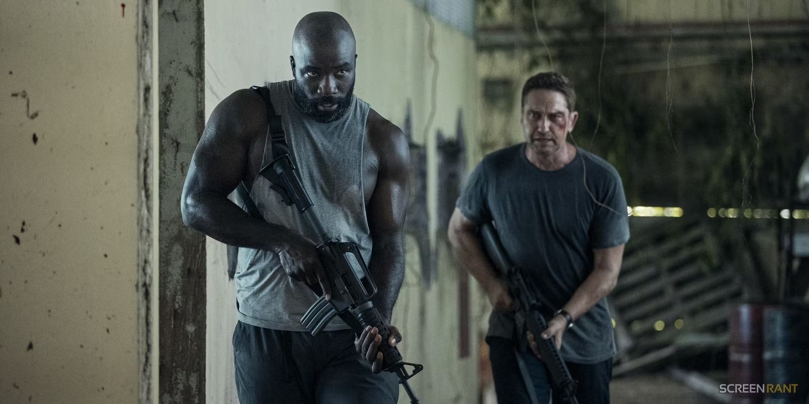 Mike Colter and Gerard Butler holding guns in Plane.