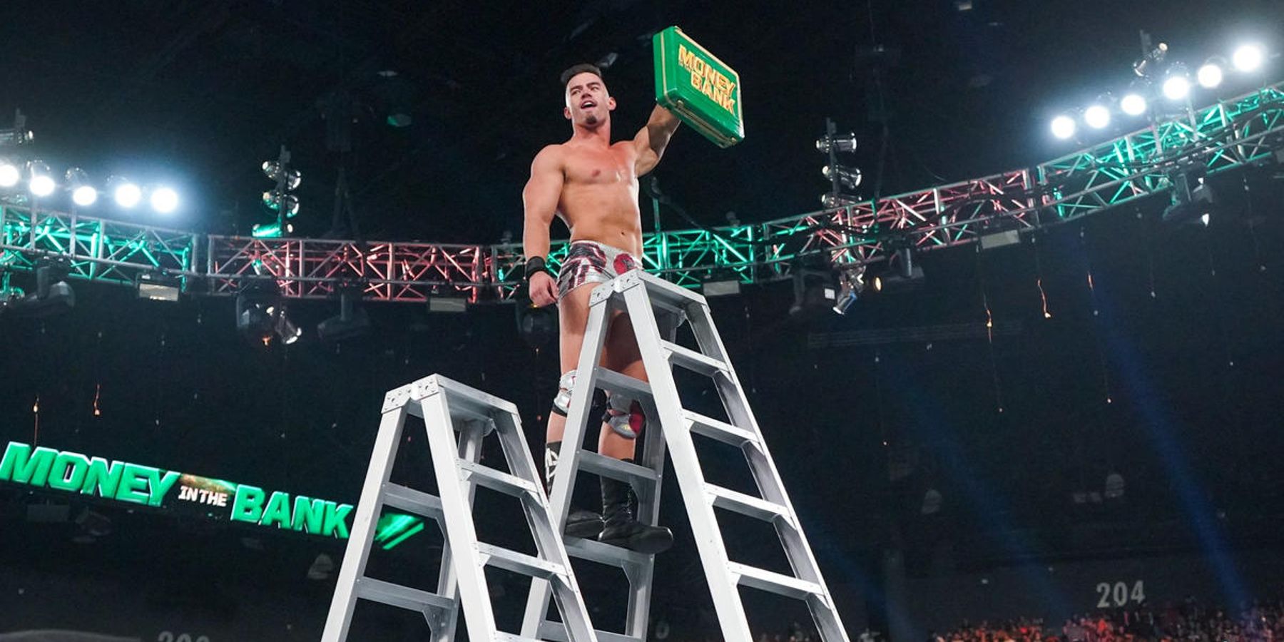 Austin Theory smugly celebrates after winning the men's Money In The Bank ladder match in 2022.