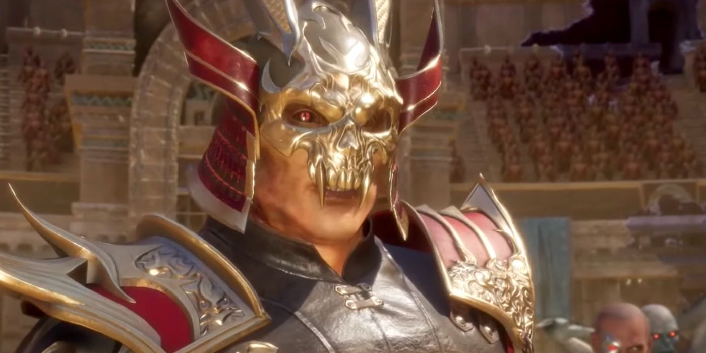 A screenshot of Shao Kahn in Mortal Kombat 11. His ornamental gold and red armor resembles that of samurai, but the front of his helmet is in the shape of a skull with large fangs.
