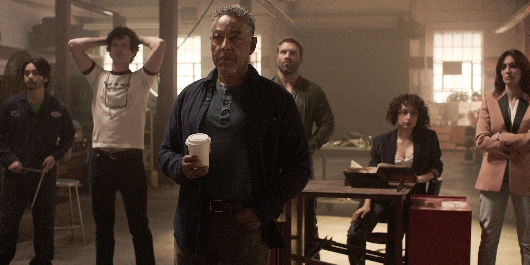 Netflix&rsquo;s Kaleidoscope Cast standing and looking at the screen of something