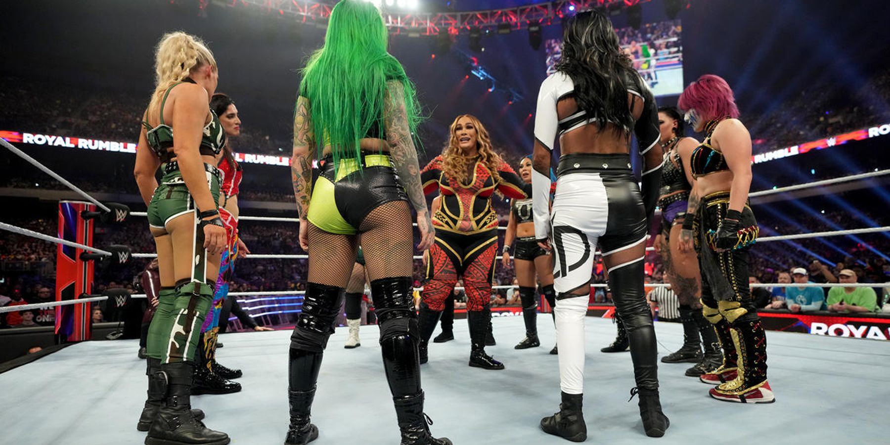 11 other wrestlers surround Nia Jax after she made her return at WWE's Royal Rumble in 2023.
