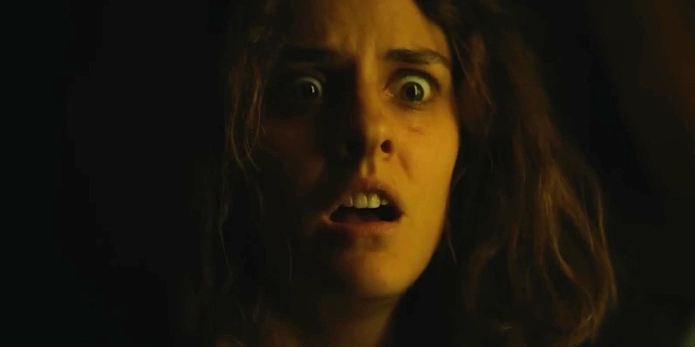 Noemie Merlant the in trailer for the horror film Baby Ruby, making a horrified face against a black background