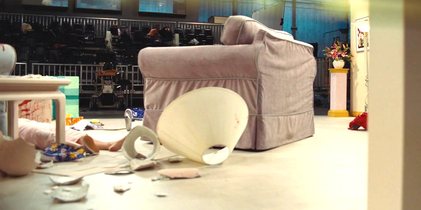 A single shoe impossibly hovers on the floor amid the carnage of a trashed TV set, a dead or unconscious woman lying nearby with one shoe off