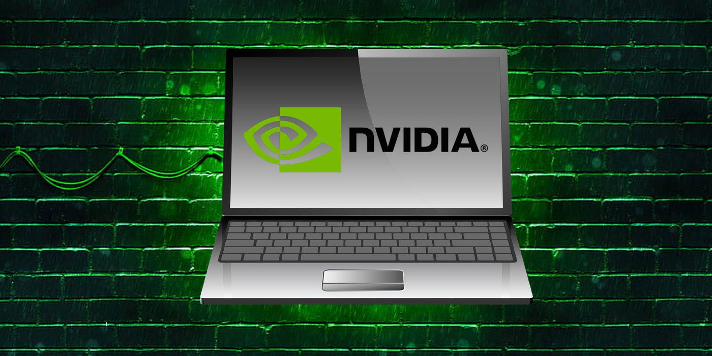 Open laptop with on-screen Nvidia logo in the foreground and a brick wall with green lighting in the background.