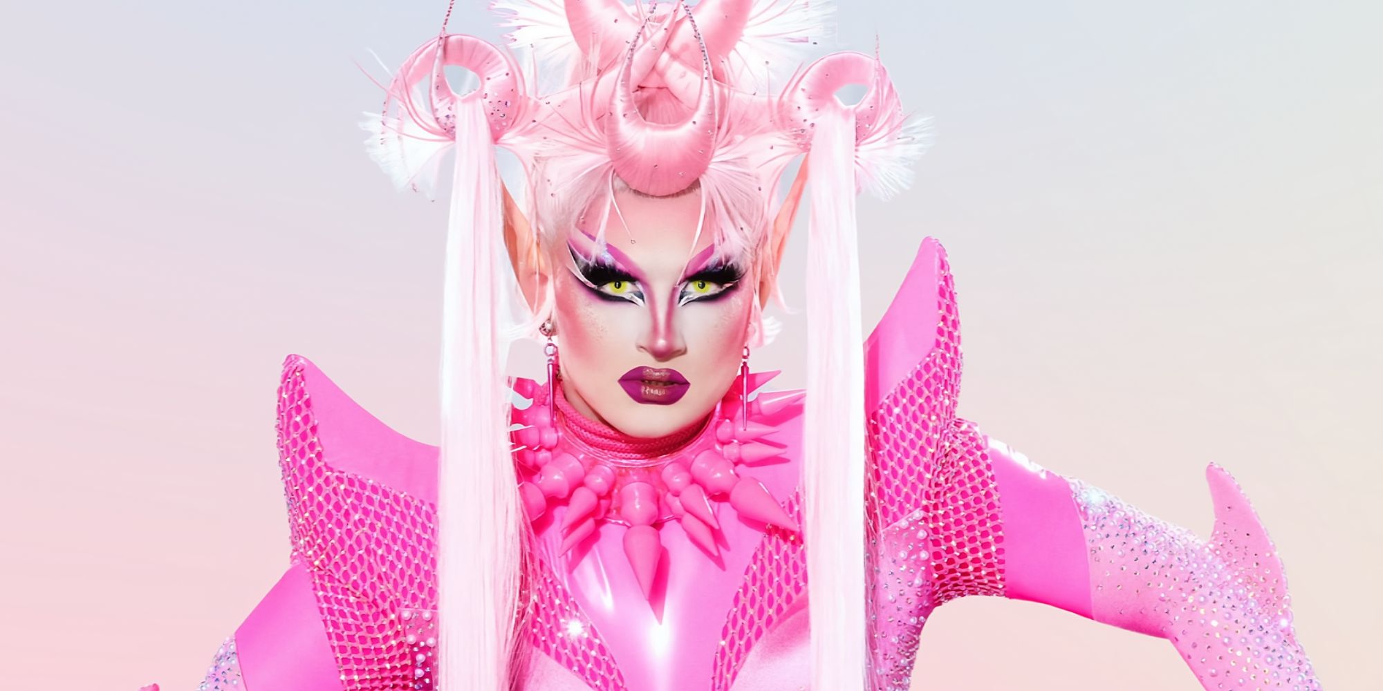 Irene Dubois From RuPaul's Drag Race Season 15 in an all-pink outfit with a serious expression