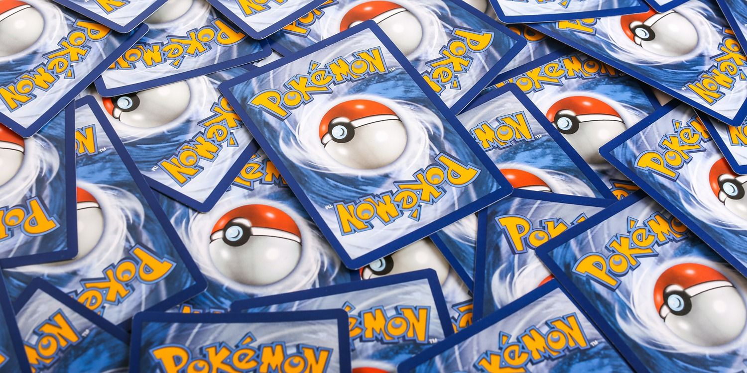 A pile of face-down Pokémon cards, showing the series logo and a Poké Ball on the back of each one.