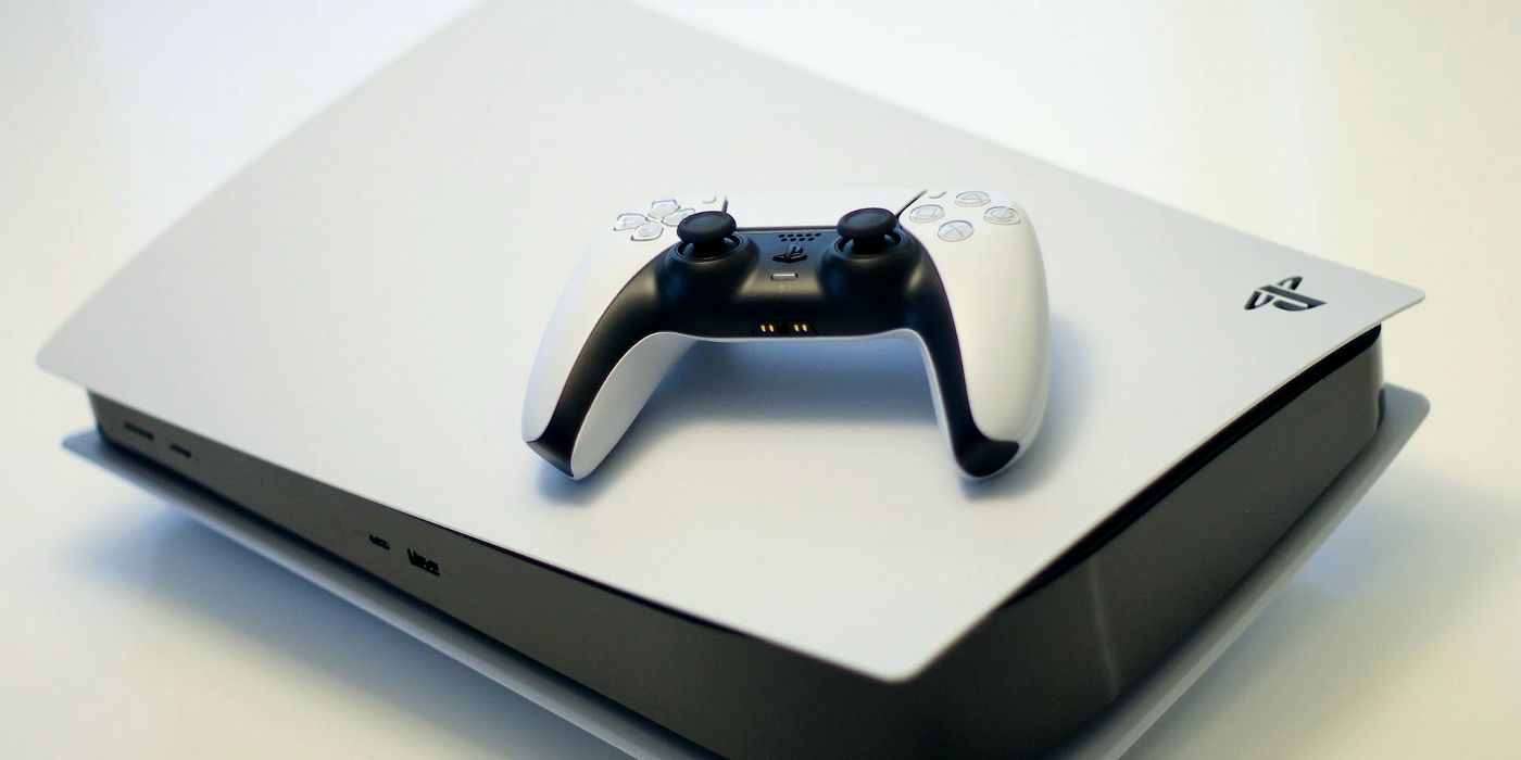 A PS5 controller resting on top of the console
