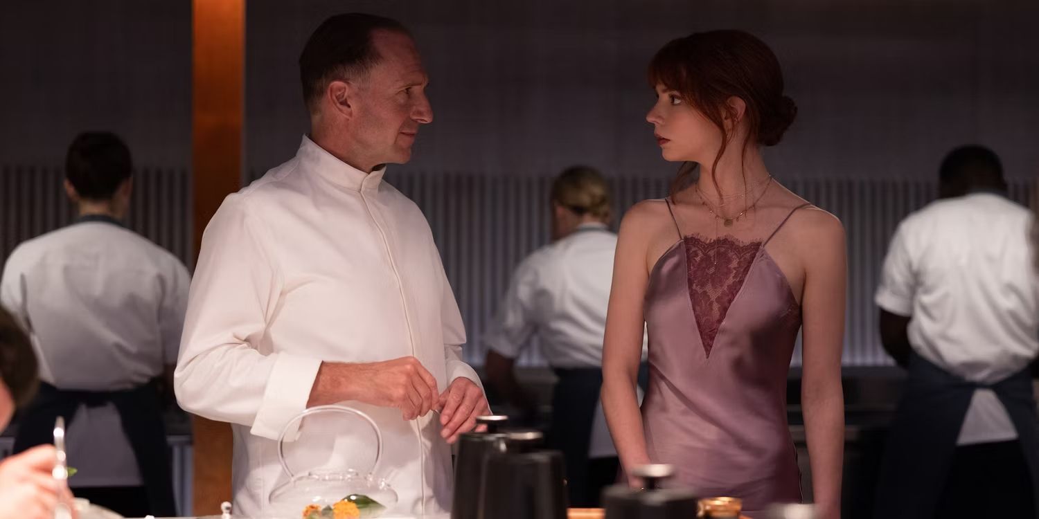 Ralph Fiennes and Anya Taylor Joy talking in The Menu