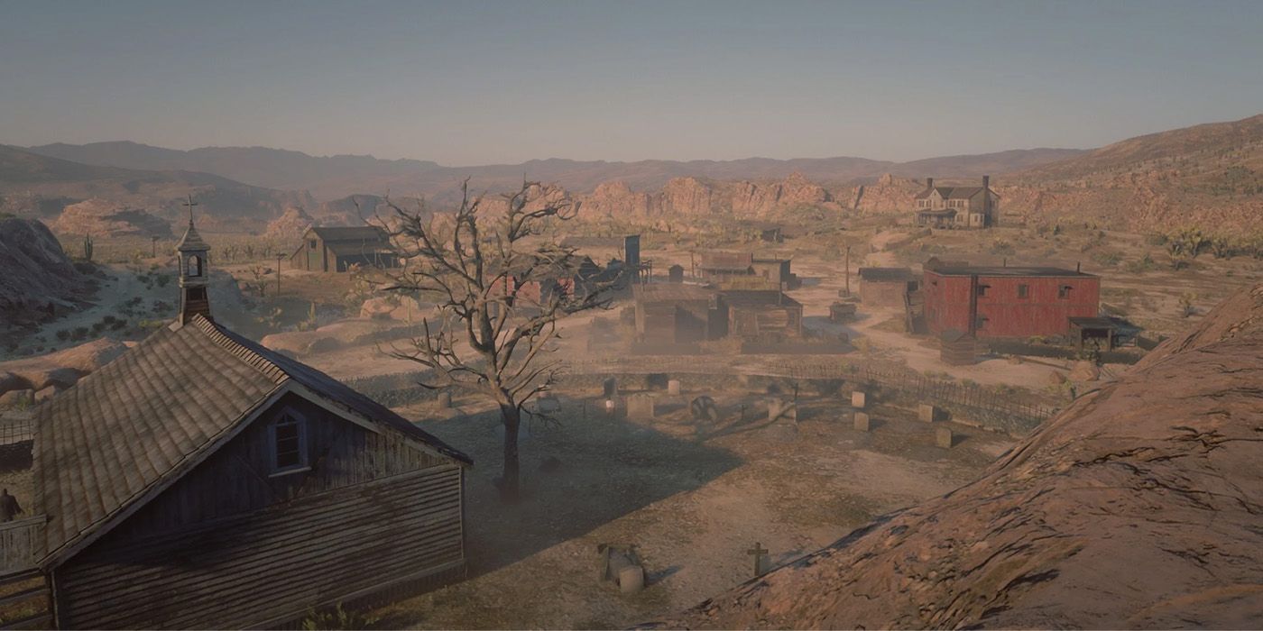 Image of Tumbleweed town in Red Dead Redemption 2, featuring several dusty building and a leafless tree.