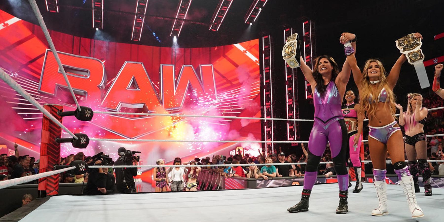 Raquel Rodriguez and Aliyah celebrate winning the WWE Women's Tag-Team Championship in 2022.