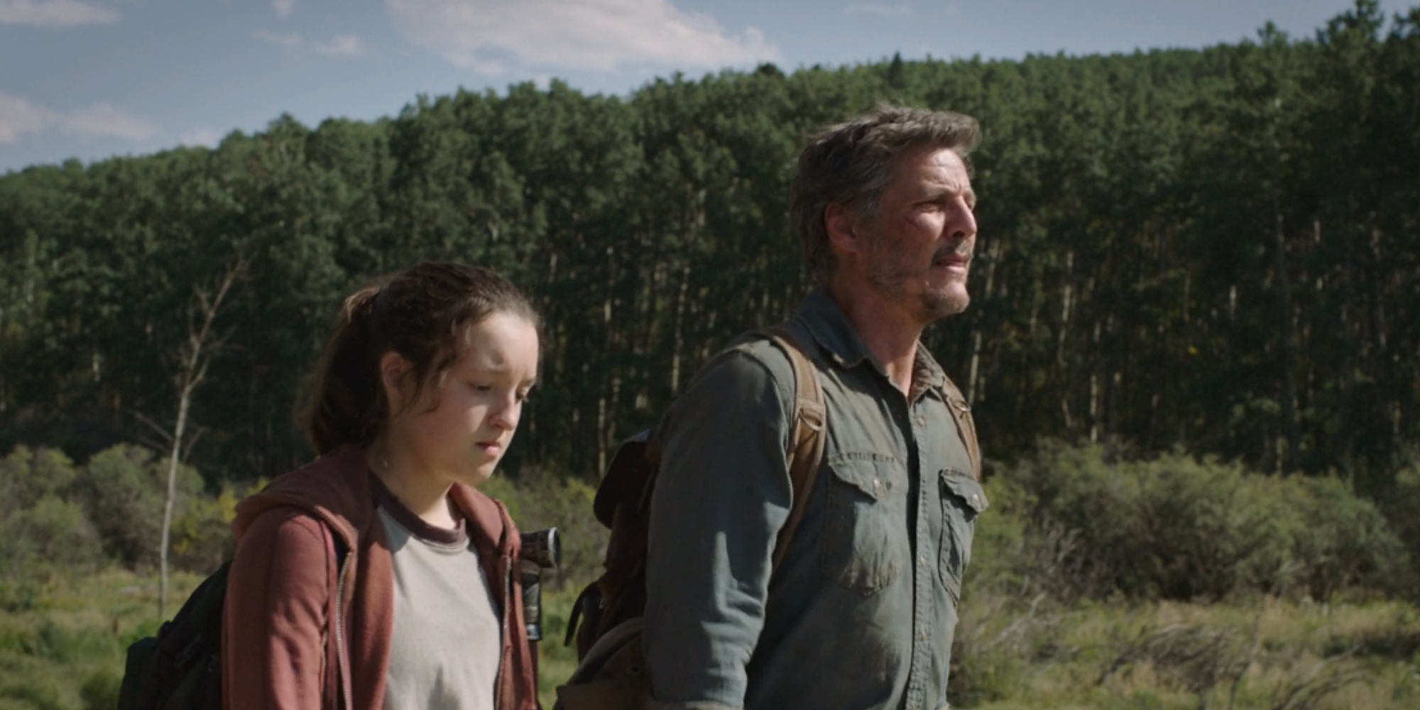 Pedro Pascal and Bella Ramsey walking on the road in The Last of Us