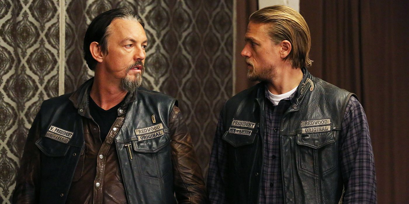 Chibs (Tommy Flanagan) and Jax (Charlie Hunnam) look at each other in the leather vests in Sons of Anarchy