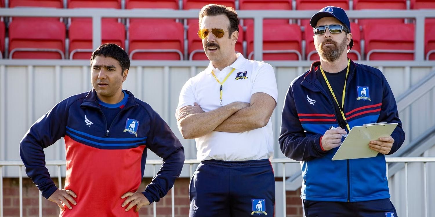 Ted Lasso, Nate, and Beard watching from the sideline in Ted Lasso 