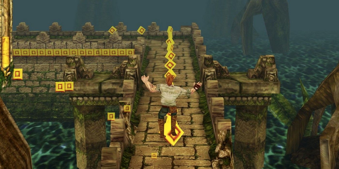 A gameplay image from Temple Run showing an adventurer jumping across a temple course. 