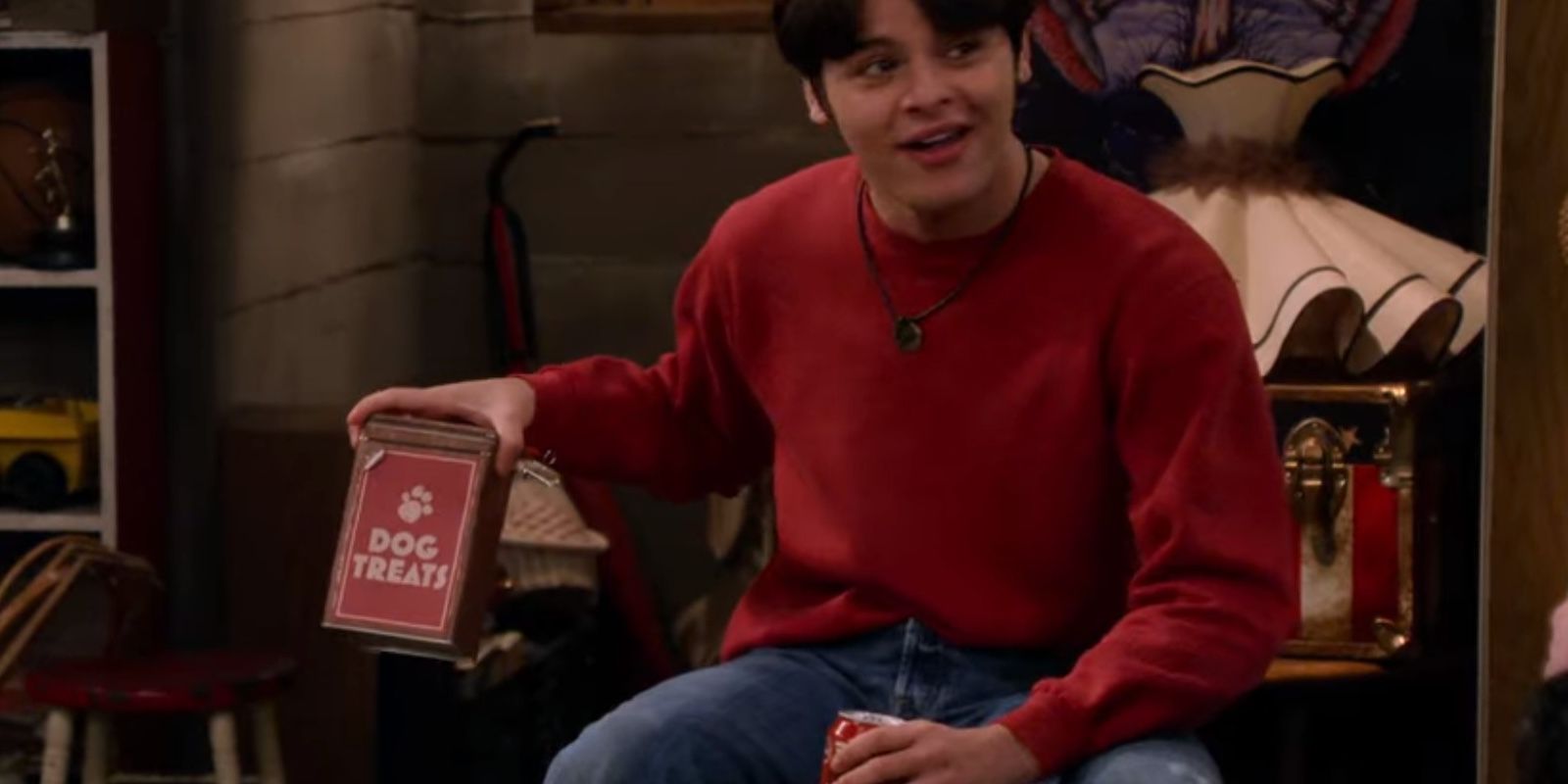 Jay Kelso holds a tin of dog treats in the Forman basement in That 90s Show