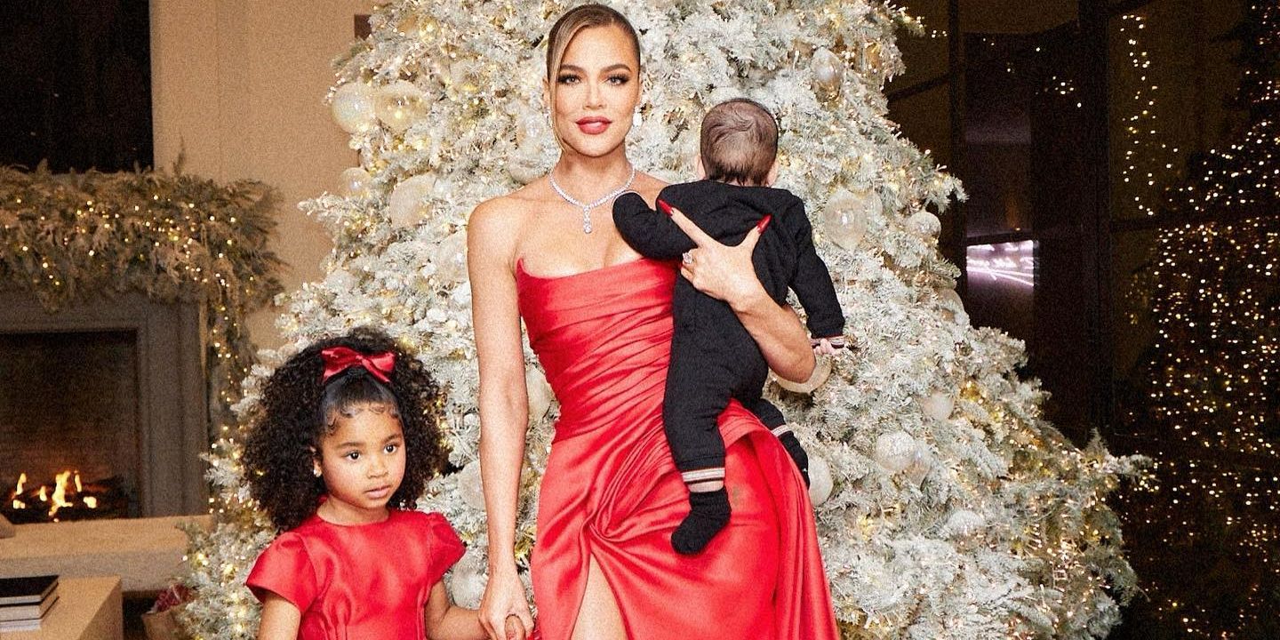 Kardashian star Khloe Kardashian and her two children in front of the Christmas tree