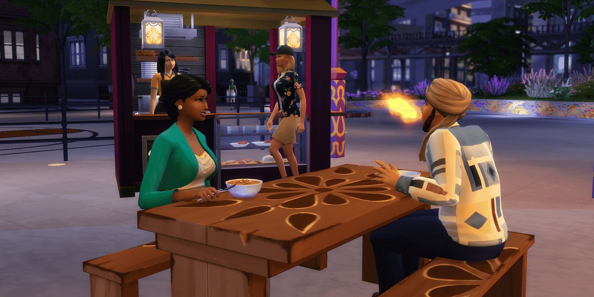 Two Sims eating while downtown in The Sims 4 City Living, the food booth is in the background