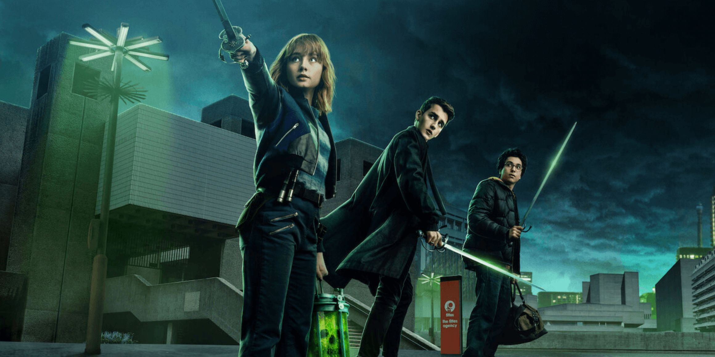 Three of the teens in Lockwood and Company holding swords while they look behind them in a Netflix promotional image