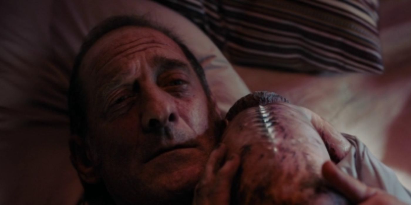 Vincent holds the human-car baby in Titane