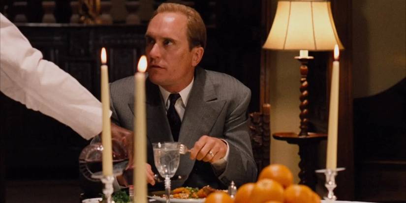 Robert DuVall as Tom Hagen eating dinner in The Godfather.
