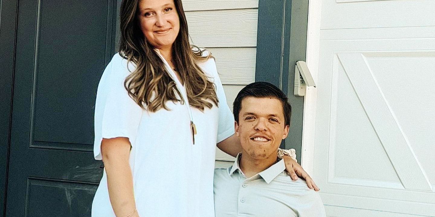 Tori and Zach Roloff standing in front of a garage door and smiling