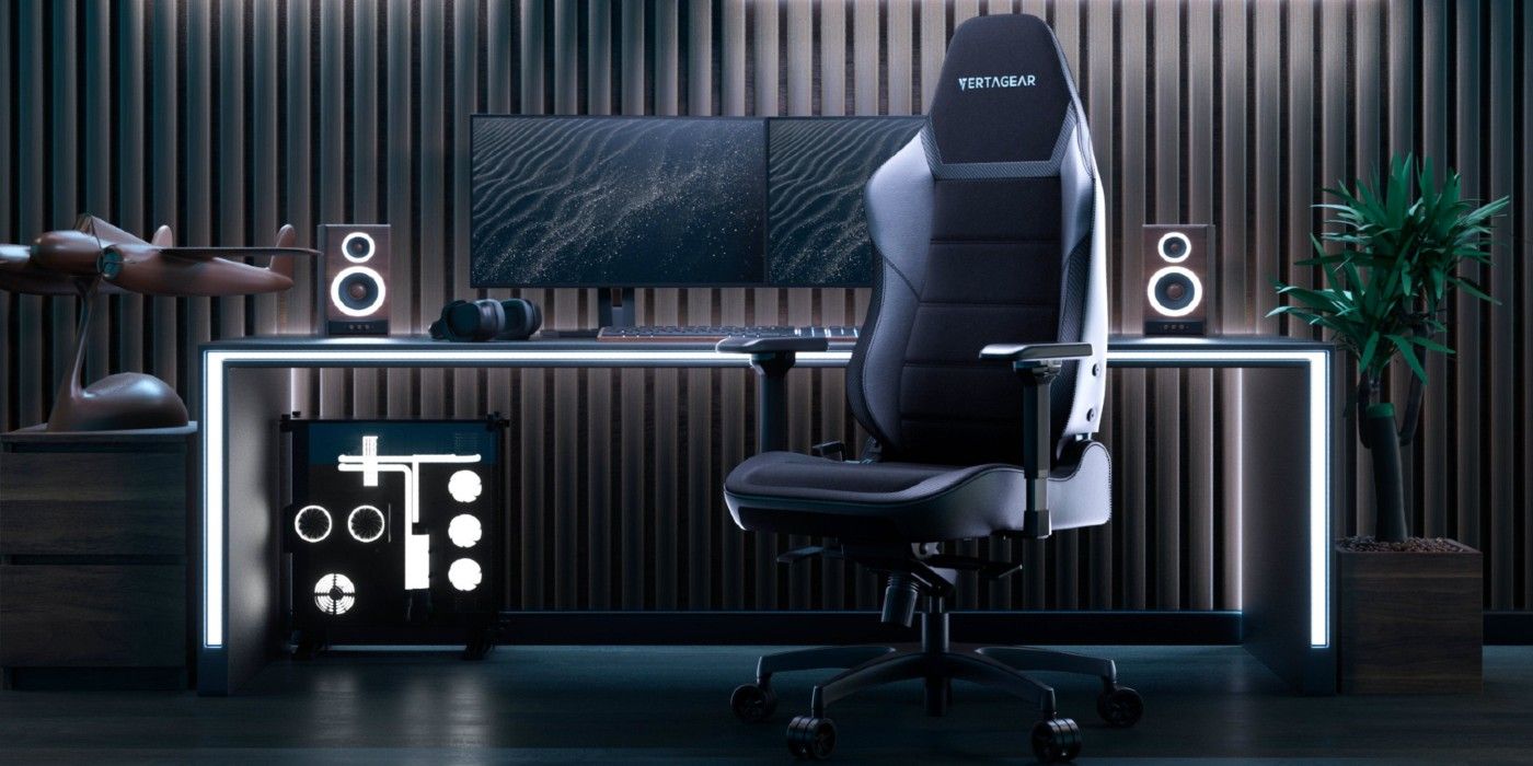 Vertagear PL6800 Gaming Chair in front of a computer set-up with lights glowing in the dark.