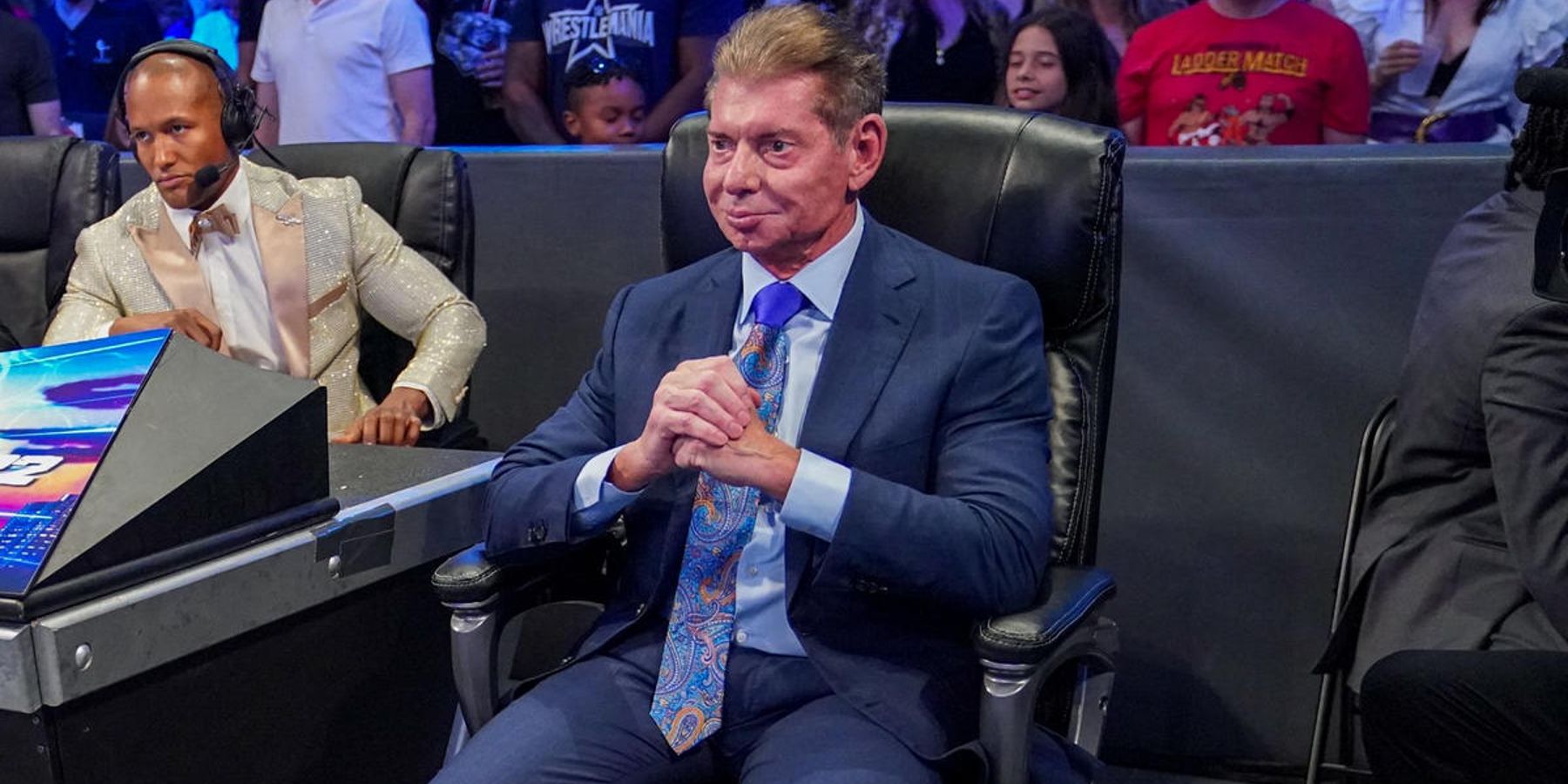Vince McMahon watches a match between Austin Theory and Pat McAfee at WWE WrestleMania 38.