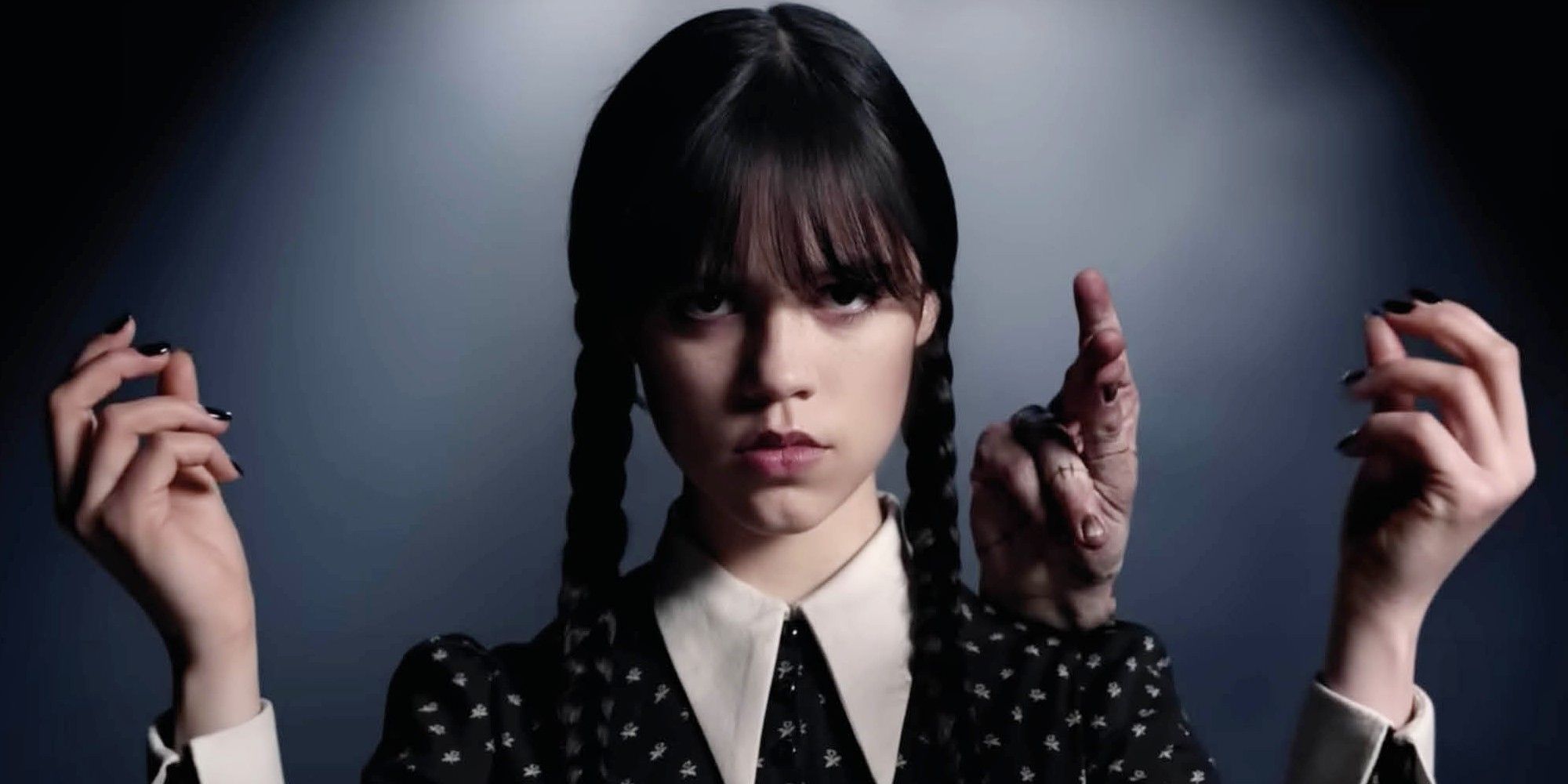 Jenna Ortega as Wednesday snaps her fingers with Thing on her shoulder in Wednesday