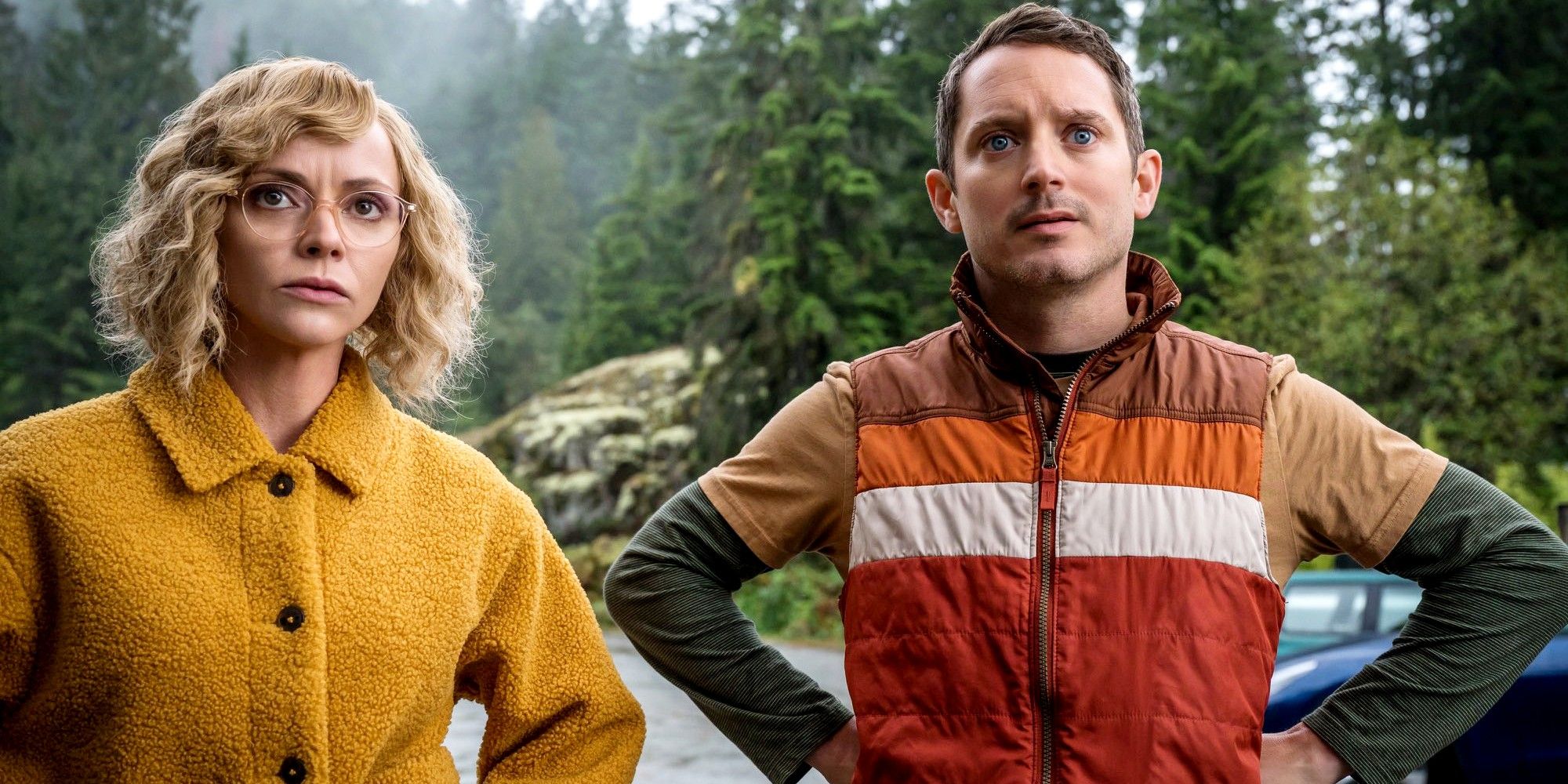 Christina Ricci as Misty and Elijah Wood as Walter looking confused in a forest in Yellowjackets.