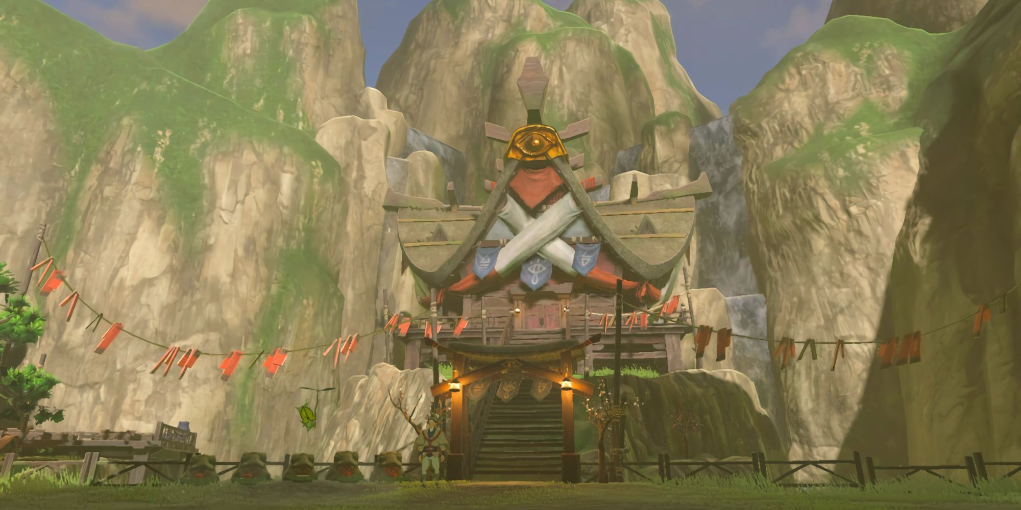 An exterior view of Impa's house in Breath of the Wild's Kakariko Village. Behind the building are the tall stone cliffs that surround the whole village.