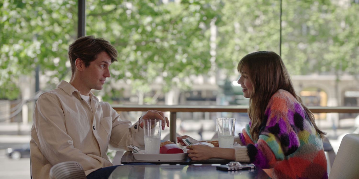 An image of Emily and Gabriel talking to each other over a McDonalds in Emily in Paris