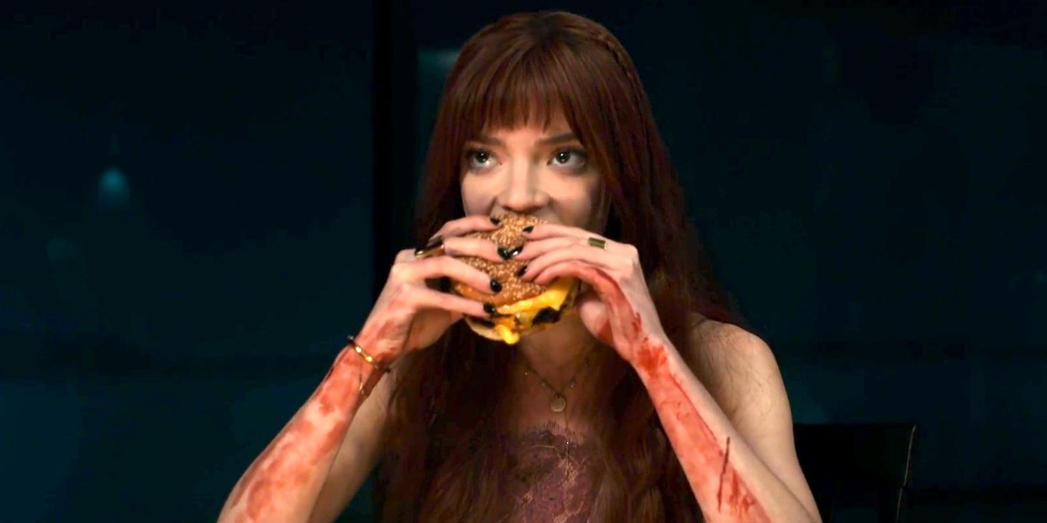 Anya Taylor-Joy as Margot eating a Cheeseburger in The Menu