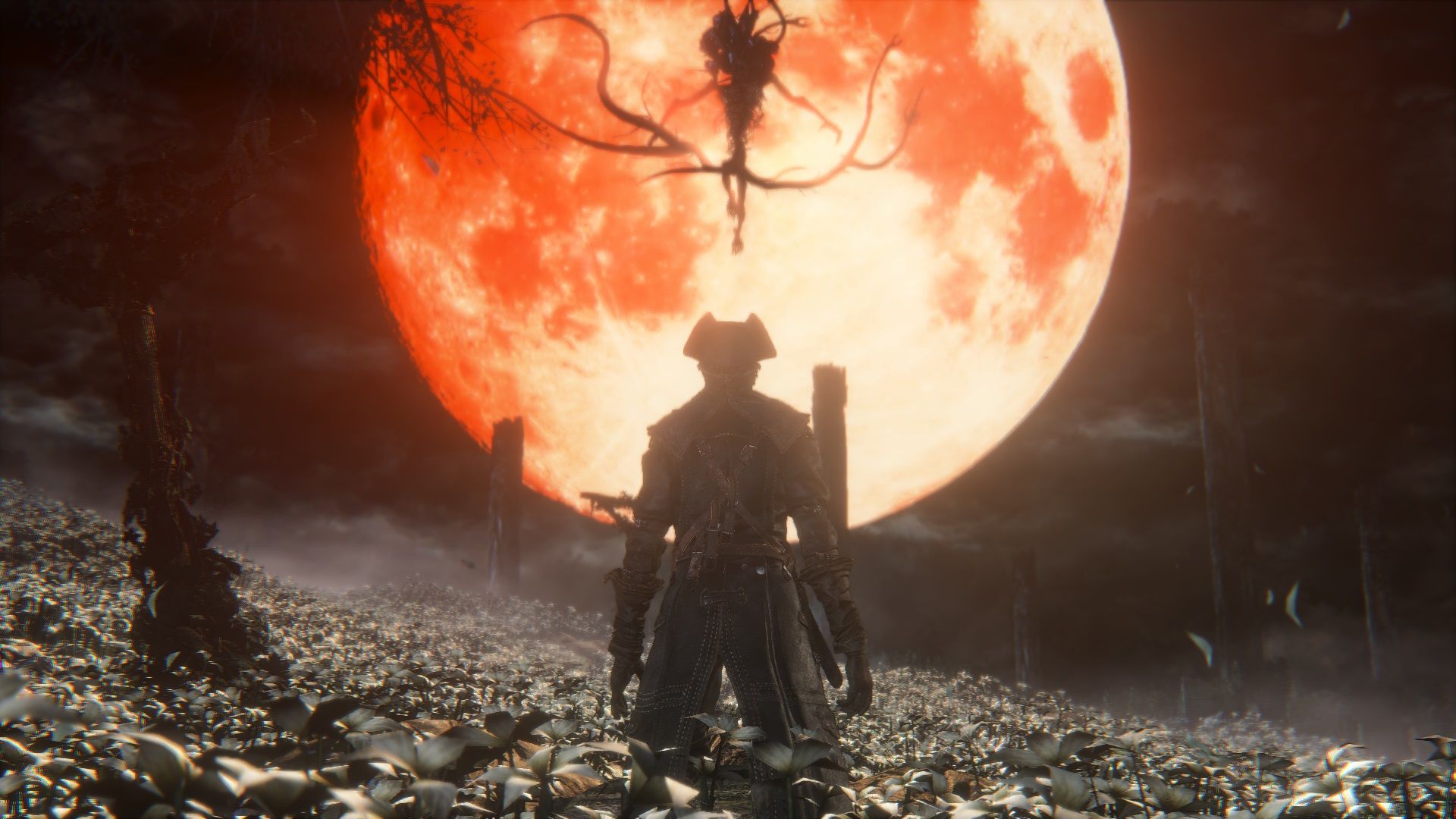 Bloodborne&rsquo;s Moon Presence boss descends from the Blood Moon to face the Hunter in the Hunter&rsquo;s Dream. The Hunter stands in a field of flowers at night.