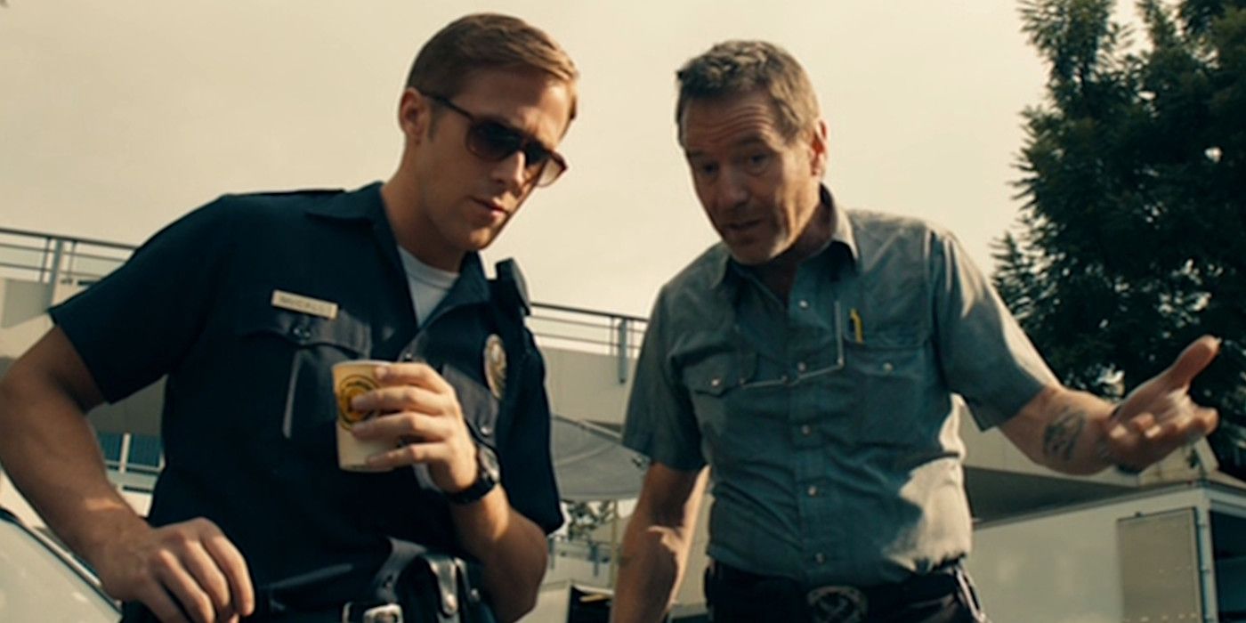Ryan Gosling in a cop uniform in the movie Drive, having an animated conversation with Bryan Cranston